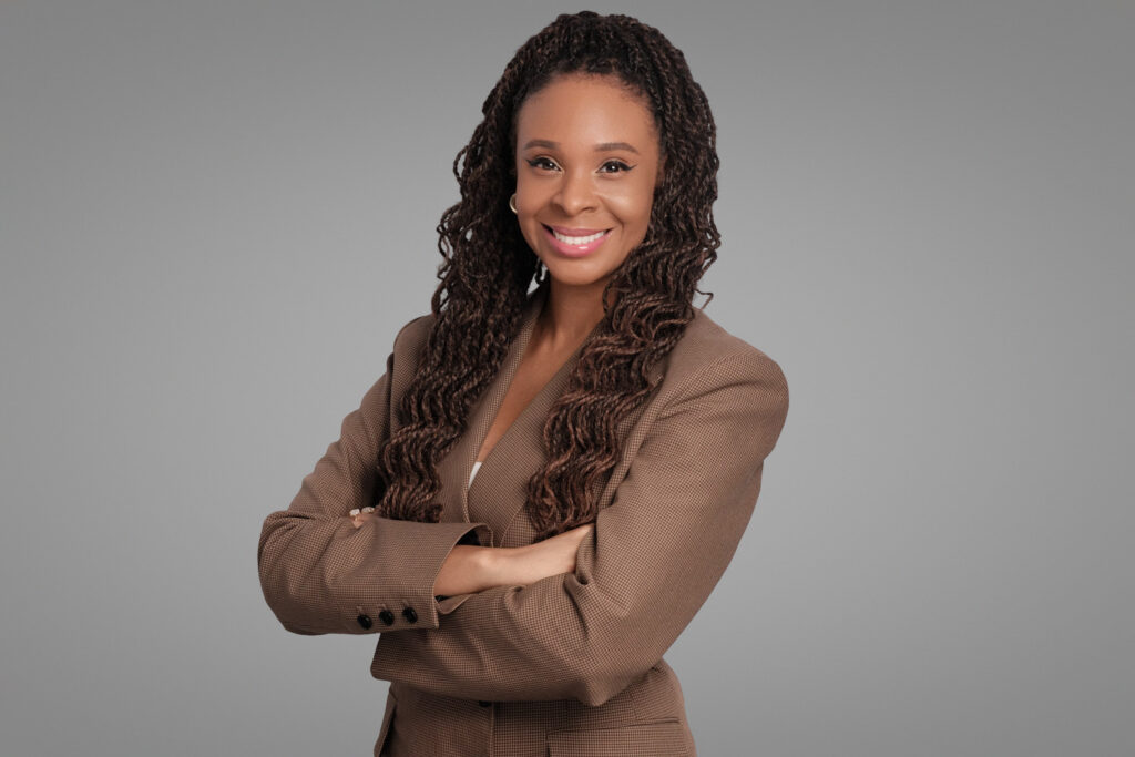 Woman in neutral taupe blazer with arms crossed, photographed by Boston headshot photographer